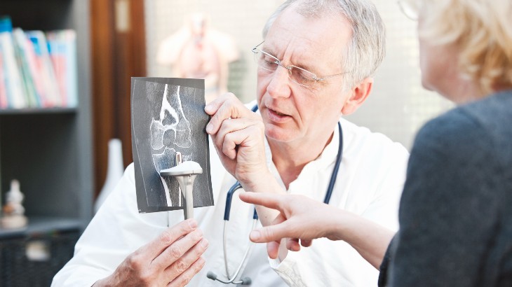 orthopedic surgery image of doctor talking to patient with xray from rome health hospital near rome ny
