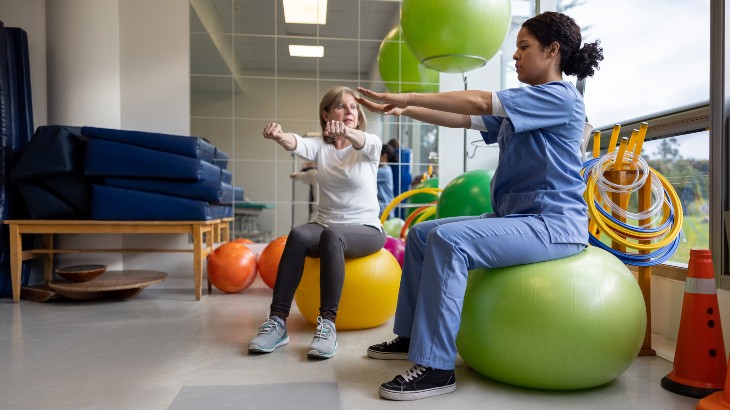 physical therapy image of therapist showing stretches to patient at rome health hospital near rome ny