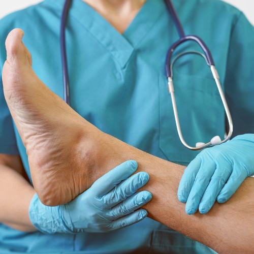 Podiatry physicians image of doctor examining patients foot from rome health near rome ny