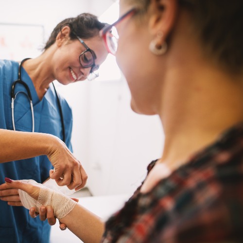 Wound Care Specialists image of doctor treating patients arm at rome health near rome ny