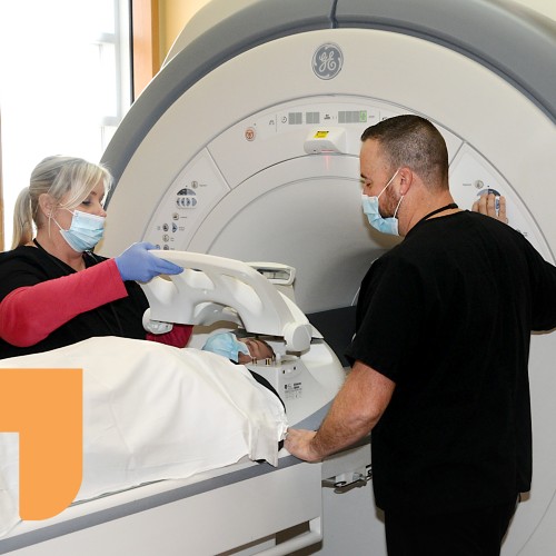 Radiology physicians listing image of doctors using MRI with patient at rome health near rome ny