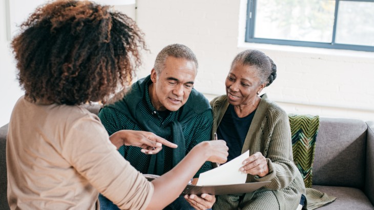 Medical Financial Assistance image of female doctor speaking with clients about options at rome health near rome ny