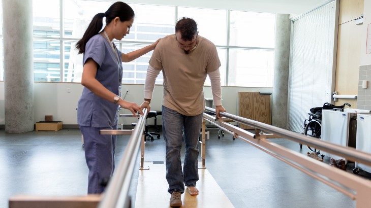 Occupational Therapy image of woman helping man to walk for first time from rome health hospital near syracuse ny