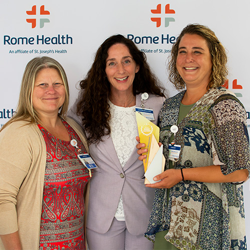 CEO AnneMarie Czyz with staff members receiving the MEMIC award